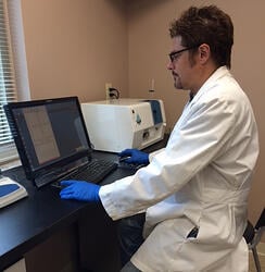 Scientist using FlowCam to analyze protein therapeutics