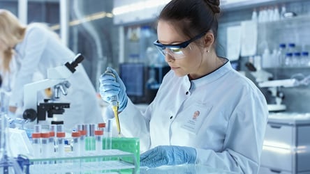 Scientist working in lab using pipettor