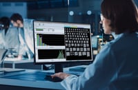 Scientist looking at screen with images and data