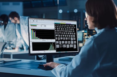 Scientist looking at screen with images and data