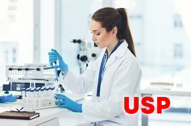 scientist in lab using pipetter with USP