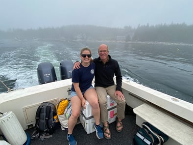 Savannah Judge and Harry Nelson riding ferry to Hurricane Island sitting on top of FlowCam crate