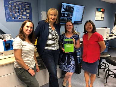 FlowCam scientists with Natasha Barteneva showing off her textbook