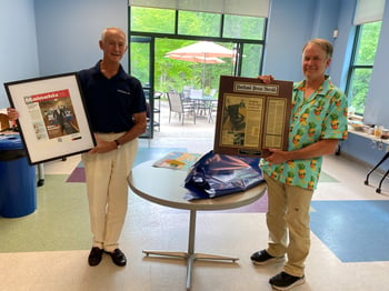 Fluid Imaging Technologies' Kent Peterson and Chris Sieracki at retirement party, showing framed news articles