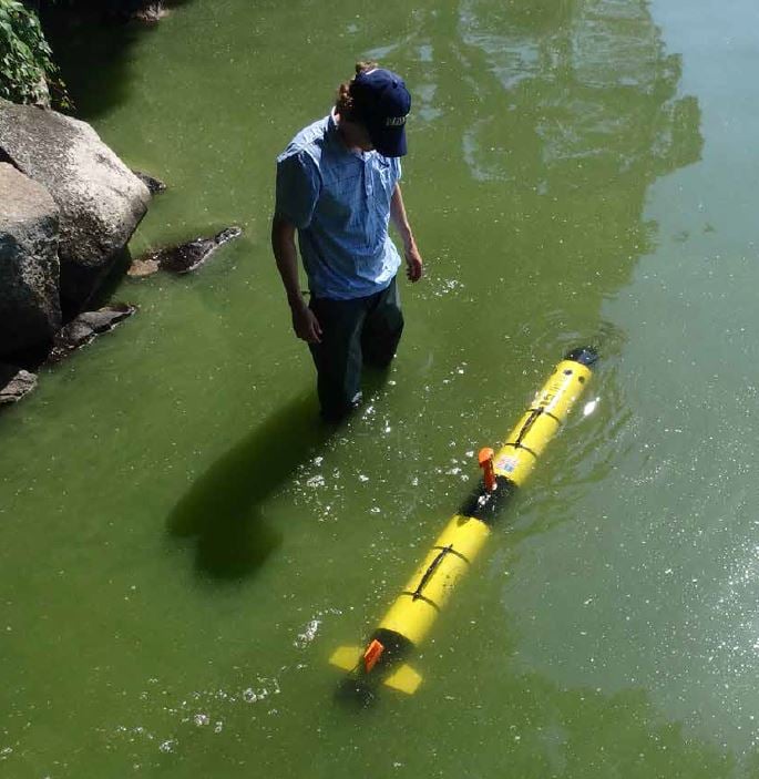 Person using multiparameter sonde to collect water quality data