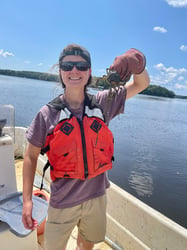 FlowCam grant winner holding crab on boat