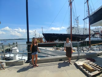 FlowCam grant winners from Maine Maritime Academy standing on dock in front of boats