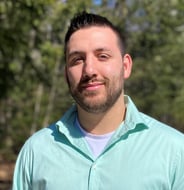 Headshot of man with light green shirt