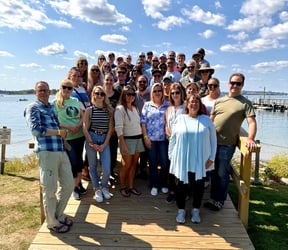 The FlowCam team standing on a dock with an ocean view in the background