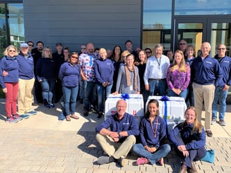 FlowCam team group photo at Bigelow labs with two FlowCam crates with bows