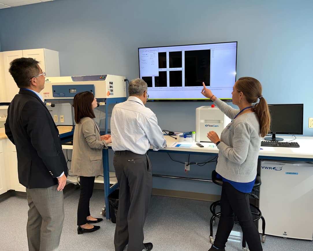 Scientist giving FlowCam demonstration in lab