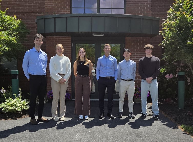 6 people standing in front of an office building
