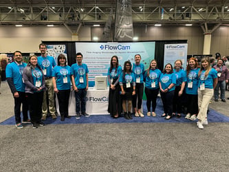 Group of people in FlowCam tshirts standing at exhibitor booth