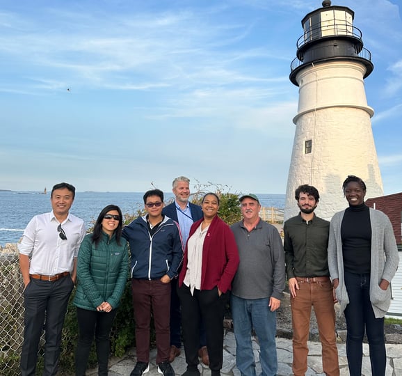 Group of people in front of lighthouse