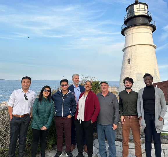 Group of people in front of lighthouse