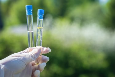 Hand holding test tubes