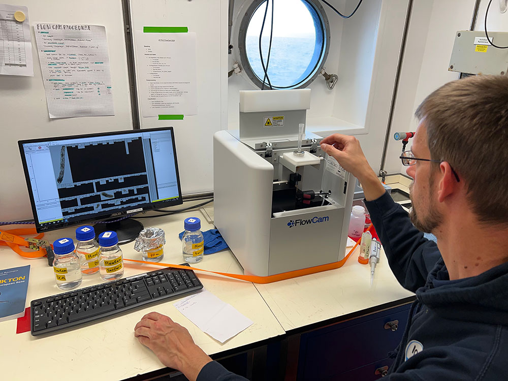 Scientist using FlowCam imaging flow cytometer onboard research vessel in Patagonia