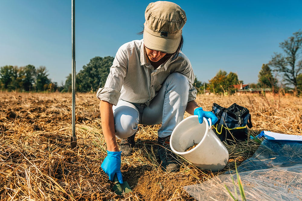 Woman collecting a soil sample