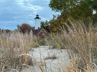 Lighthouse with sand and beach grasses