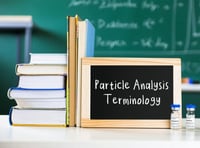 Lab bench with books, sign, and vials