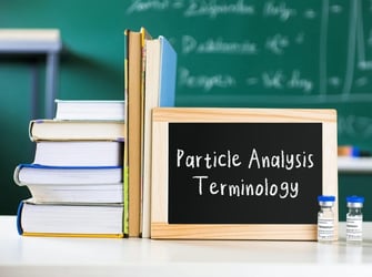 Lab bench with books, sign, and vials