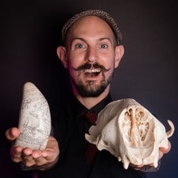 Portrait of Russell Arnot holding bones from marine organisms