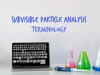 laptop with particle images, beakers, pipetter, 