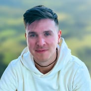 Headshot of man with dark hair and white shirt
